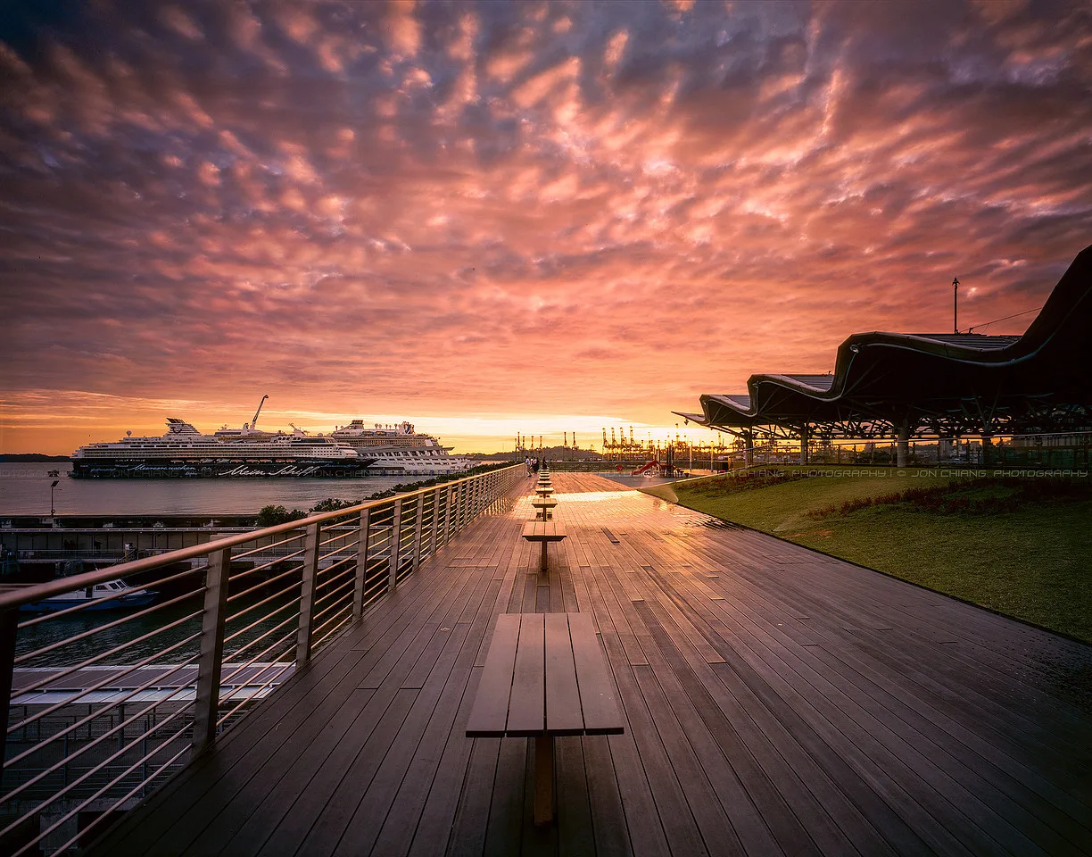 Decking leading into a sky going pink and grey.