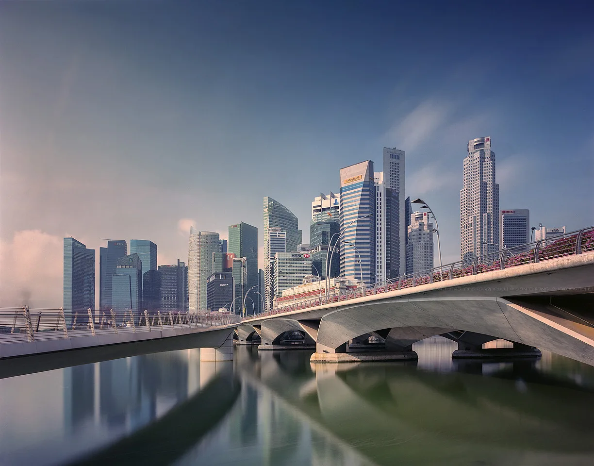 The financial district behind a low bridge, flattened by distance.