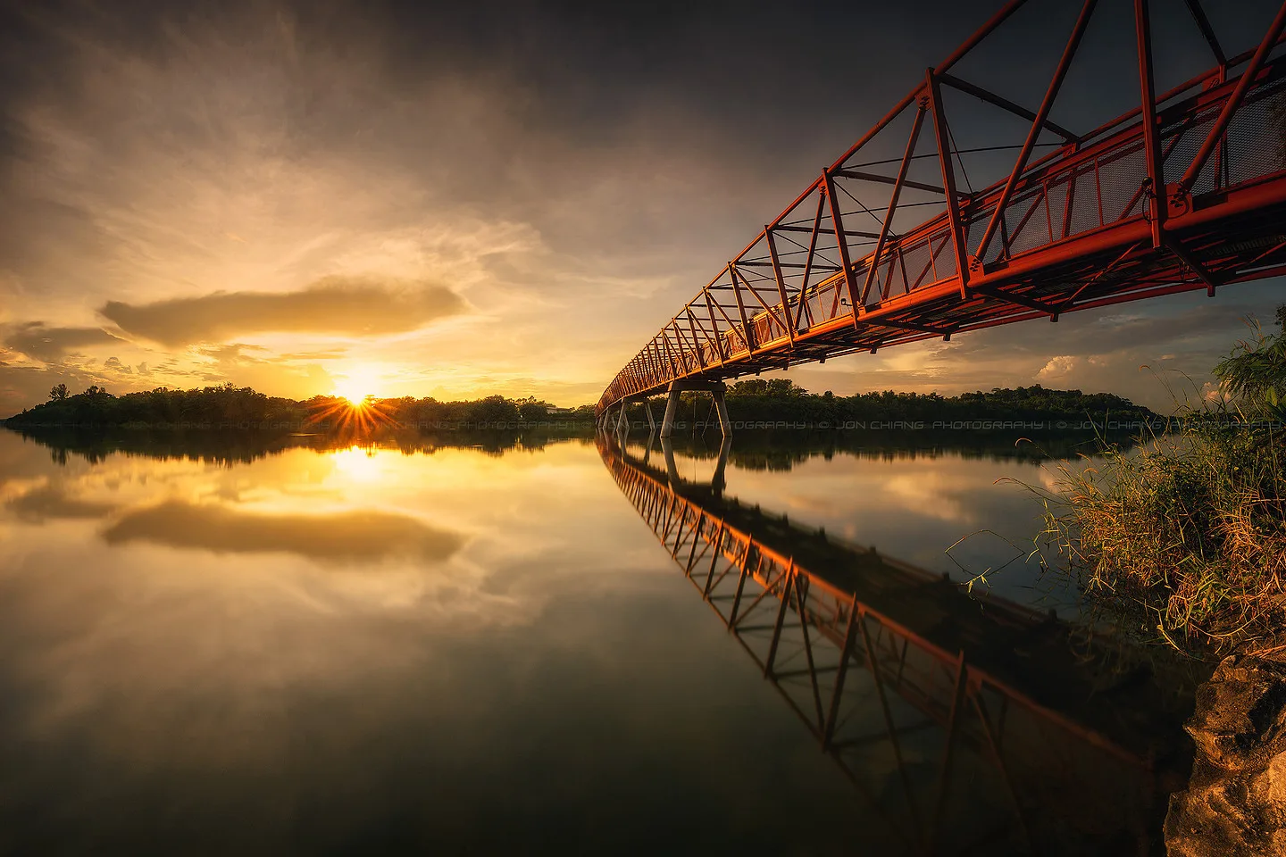 Still water carrying the sun back up through the span.